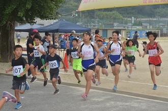 写真：出発点の土岐小学校から走り出していくランナーたち